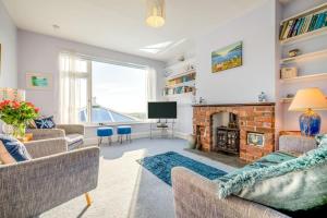 a living room with a fireplace and a tv at 4 Bed in Tintagel oc-trev in Treknow