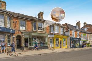 a group of people walking down a city street at 1 Bed in Southwold oc-bate in Southwold