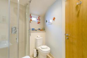 a bathroom with a toilet and a glass shower at 1 Bed in Southwold oc-bate in Southwold +6 photos