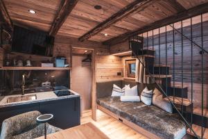a room with a couch and a kitchen in a house at BergNest in Huben +12 photos