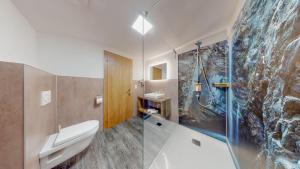 a bathroom with a shower and a toilet and a sink at Appartement Belmonte in Sölden
