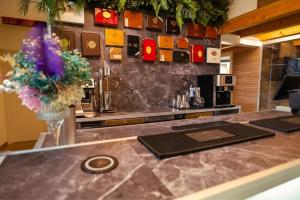a kitchen with a counter top with a vase of flowers at Haven Loft Como - Private Spa, Parking & Jacuzzi in Como +55 photos