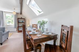 a dining room with a wooden table and a window at 2 Bed in Appledore oc-gable in Appledore