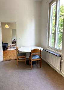 a dining room with a table and two chairs at Apartment Centrum Karlshamn in Karlshamn