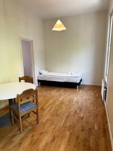a room with a bed and a table and chair at Apartment Centrum Karlshamn in Karlshamn