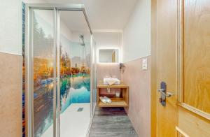 a bathroom with a shower with a painting on the wall at Appartement Belmonte in Sölden