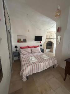 a bedroom with a bed and a fireplace at Masseria Pelosella B&B in Fasano +12 photos