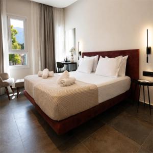 a bedroom with a large bed with towels on it at ASO Hotel - Historic Raisin Warehouse 1928 in Kalamata +133 photos