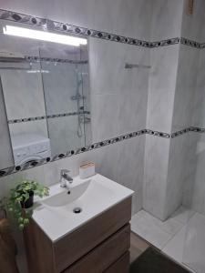 a white bathroom with a sink and a shower at Formentor Inn in Salou