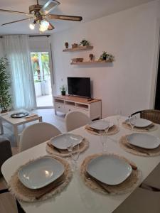 a dining room with a white table and chairs at Formentor Inn in Salou