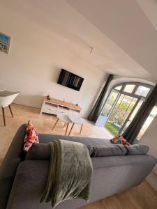 a living room with a couch and a table at Entre Loire & Château in Chaumont-sur-Loire