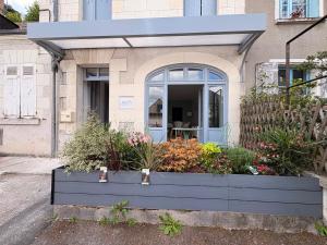 a house with a blue planter with flowers in it at Entre Loire & Château in Chaumont-sur-Loire