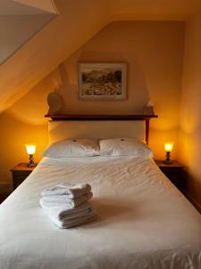 a bedroom with a bed with towels on it at Castle Viewpoint B&B in Inverness