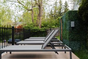 a row of benches sitting next to a fence at Lakeview on Main Pool Fire Pit and Walkable in Geneva +32 photos