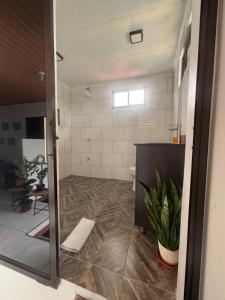 a bathroom with a toilet and a tile floor at Depa Koral in Puerto Limón +55 photos