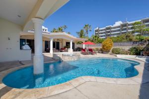 a swimming pool in the middle of a house at Casa 4 C's in Cabo San Lucas