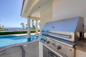 a kitchen with a grill and a swimming pool at Casa 4 C's in Cabo San Lucas