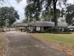 a house with a driveway in front of it at WildFlower Inn in Satsuma