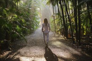 a woman walking down a path in the jungle at Spa Tour Life in Montenegro