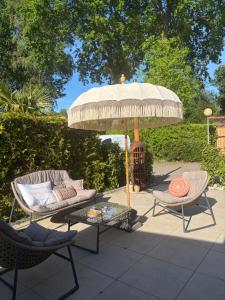 a patio with a table and an umbrella and chairs at ViVe in Putten +18 photos