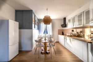 a kitchen with a table and chairs in a room at La lande appart in Tranzault