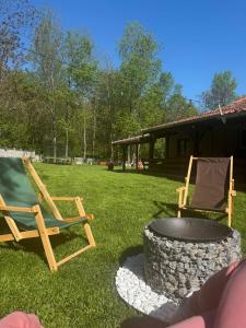 two chairs and a fire pit in a yard at Misirland in Malo Laole