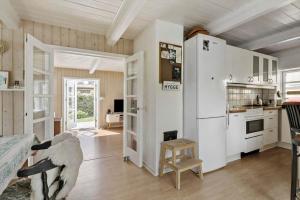 a kitchen with a white refrigerator in a room at 20623-Samso-Besser-Hovedgade-9 in Besser