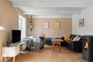 a living room with a couch and a tv at 20623-Samso-Besser-Hovedgade-9 in Besser