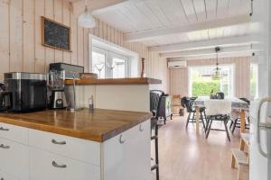 a kitchen with a counter and a table with chairs at 20623-Samso-Besser-Hovedgade-9 in Besser +19 photos