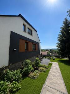a house with a green yard next to a building at Istebna Pełna Chata II in Istebna
