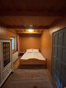 a bedroom with a bed in a room with a door at Kinga House in Keszthely
