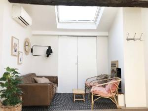 a living room with a couch and a skylight at La Mansarde du Port FAMILLY HOME in Nice
