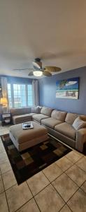 a living room with a couch and a table at Grand Caribbean in Orange Beach +37 photos
