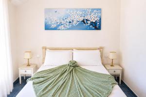 a bedroom with a bed with a painting on the wall at La Villetta Adults Only con giardino a Pula in Pula +34 photos
