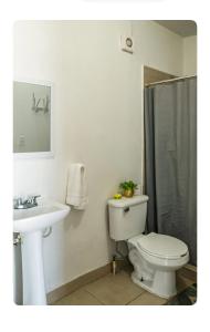 a bathroom with a toilet and a sink at Estudio #2 a 5 min del malecon in La Paz +18 photos
