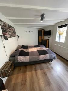 a bedroom with a bed and a wooden floor at B&Beach Zandvoort in Zandvoort