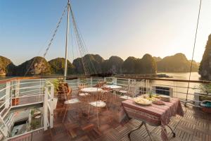 a cruise ship with tables and chairs on the deck at Petit Prince Cruise in Cat Ba