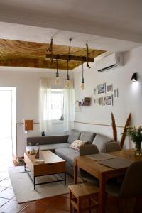 a living room with a couch and a table at Townhouse with Rooftop Terrace in Olhão in Olhão
