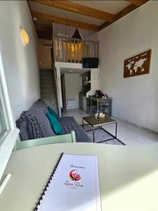 a view of a living room with a sign on a table at Studio Luna Rose in Merville