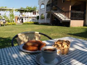 a table with a plate of bread and a cup of coffee at Apartment Dasic in Bar