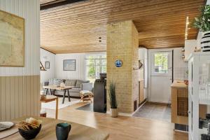 a kitchen and living room with a brick wall at 2236-Ringkobing-Fladsbjergvej-220 in Klegod