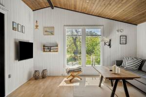 a living room with a table and a window at 2236-Ringkobing-Fladsbjergvej-220 in Klegod