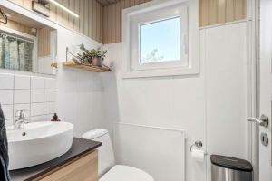 a bathroom with a sink and a toilet and a window at 2236-Ringkobing-Fladsbjergvej-220 in Klegod +26 photos