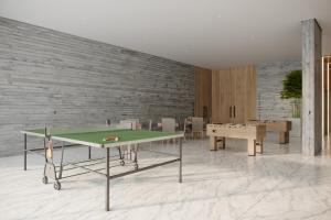 a room with a ping pong table in front of a brick wall at BEACH GAV Resorts in Salinópolis +44 photos
