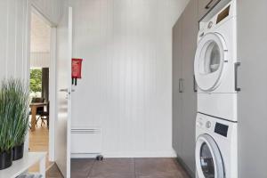 a white laundry room with a washer and dryer at OH591-Storvorde-Pilekrogen-15 in Skelby