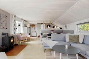 a living room with a couch and a table at OH592-Hadsund-Haslevgaarde-Bakker-12 in Øster Hurup