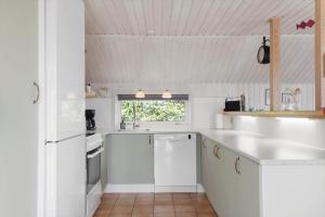 a white kitchen with white cabinets and a window at OH592-Hadsund-Haslevgaarde-Bakker-12 in Øster Hurup +14 photos