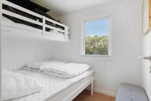 a white room with two beds and a window at OH592-Hadsund-Haslevgaarde-Bakker-12 in Øster Hurup