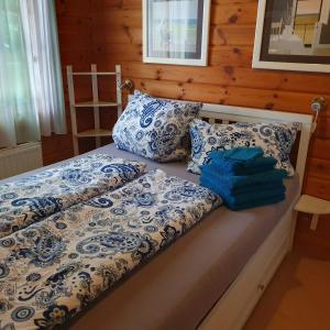 a bed with blue and white sheets and pillows at Kleine Auszeit am Twistesee in Bad Arolsen