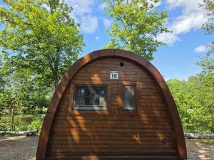 a small log cabin with a window in the front at 18 Premium Camping Pod "Fünen" in Silberstedt